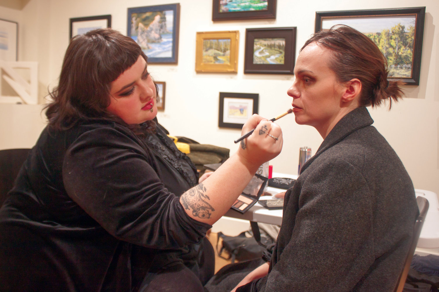 Makeup artist Susie Schaeffer (left) applies the finishing touches to lead actress Bernadette Cuvalo for the Nov. 18 shoot of “She the Creator” at Northwind Arts Center.